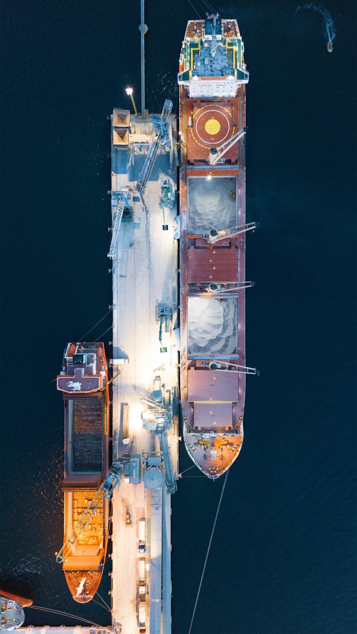 Aerial view of a container ship docked in Körfez, Kocaeli, Türkiye at night.